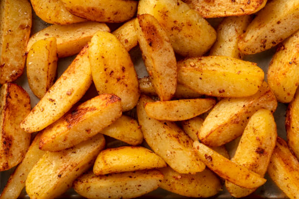istock Potato wedges, oven roasted, close-up overhead shot 1171711572