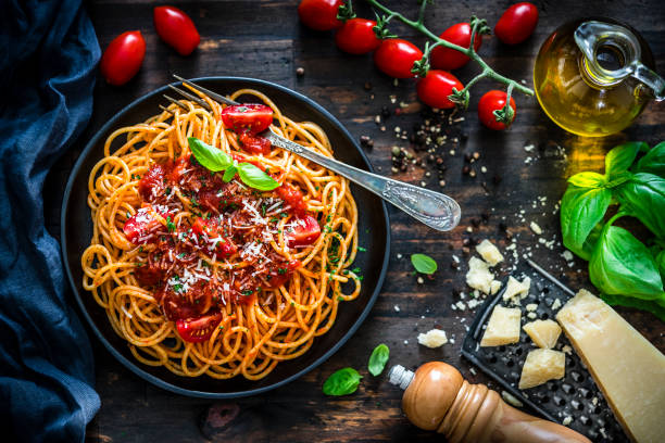 istock Spaghetti with tomato sauce shot on rustic wooden table 1171712667