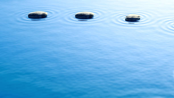 istock pebble stones in water with ripples background 1171712874