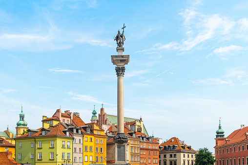 A classic view from Castle Square of Warsaw with King Sigismund's column and colourful historical houses in summer.