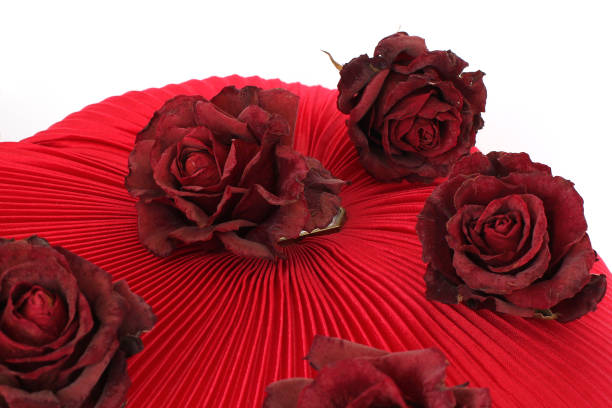 istock Dried white roses on a red background 1171714773