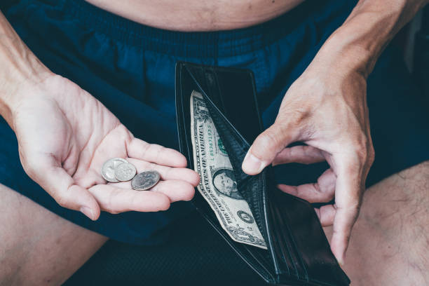 istock Close up of poor man hand with small money 1171714837