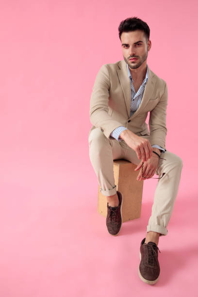 istock smart casual man holding a pair of sunglasses 1171716135