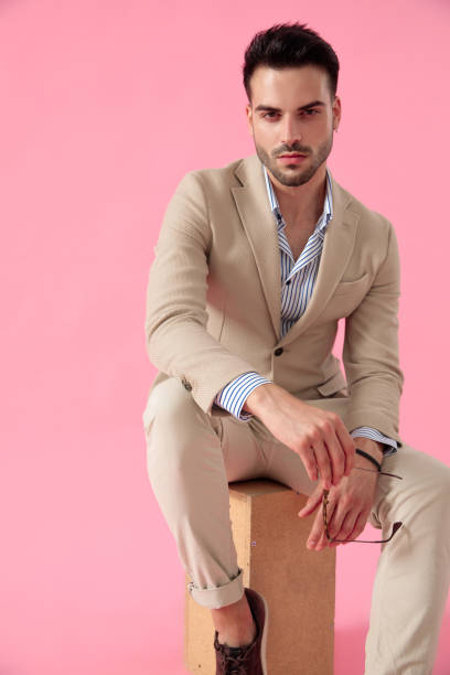 istock seductive young man sitting on wooden box 1171716156