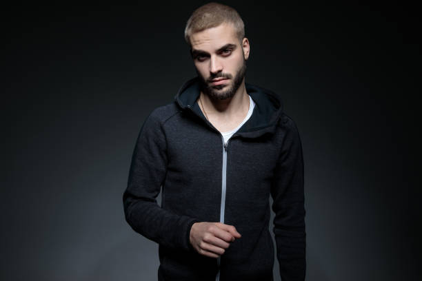 istock fit blond young man in dark grey hoodie 1171717578