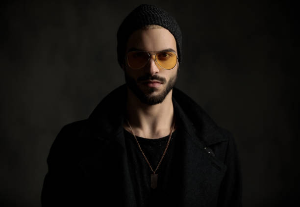 istock young hipster looking confident with orange sunglasses 1171718279