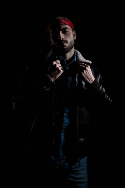 istock Confident biker adjusting his collar and looking to the camera 1171718352