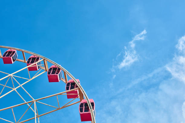 istock The pink ferris wheel against blue sky background 1171720096