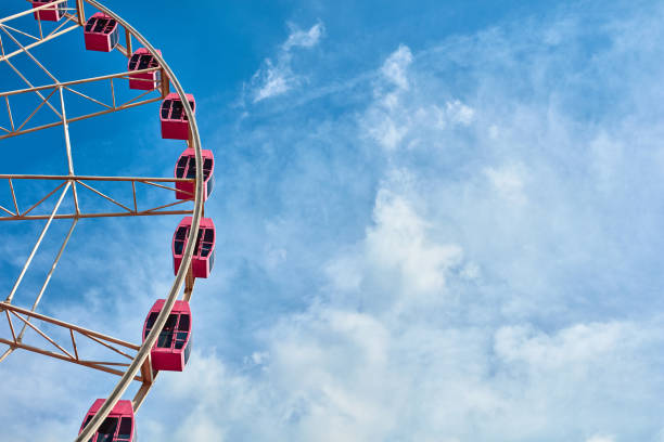 istock The pink ferris wheel against blue sky background 1171720260