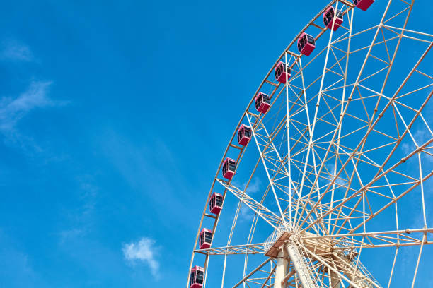 istock The pink ferris wheel against blue sky background 1171720684