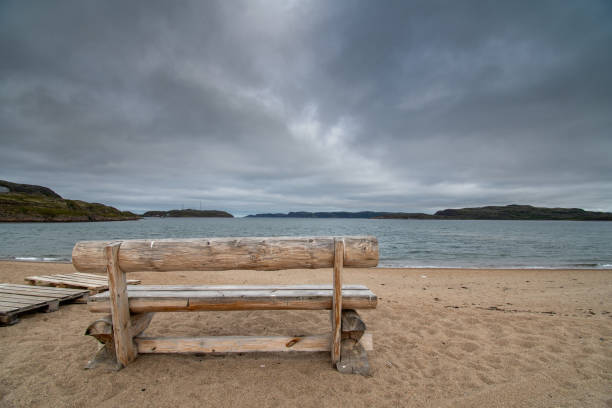 istock Lonely bench by the sea in autumn. 1171720856