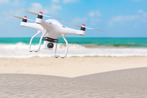Summer Vacation Concept. White Moder Air Drone with Camera above an Ocean Deserted Coast extreme closeup. 3d Rendering