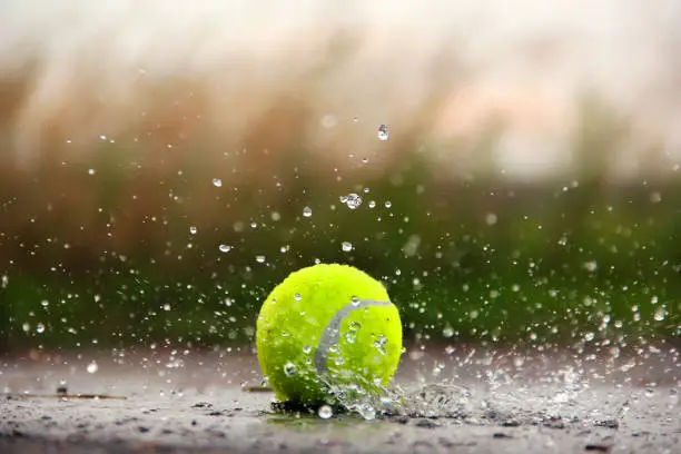 Photo of Tennis ball in the water. Tennis Ball and Water Drops