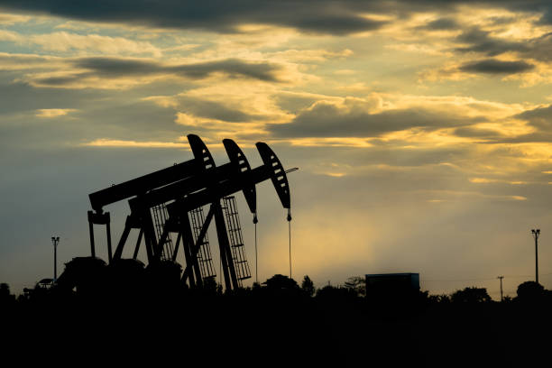 istock Beam Pump or Donkey Pump in oil field operation - View with dramatic sky 1171722233
