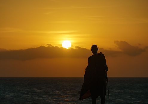 ZANZIBAR TANZANIA Silhouette of Maasai (also known as masai ) warrior at sunset in Nungwi in Zanzibar in Tanzania