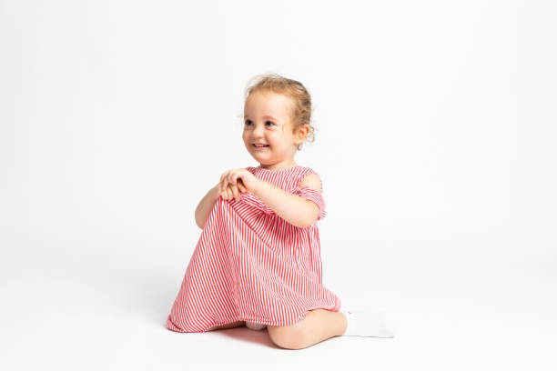 istock Happy baby girl sitting over white background 1171725032
