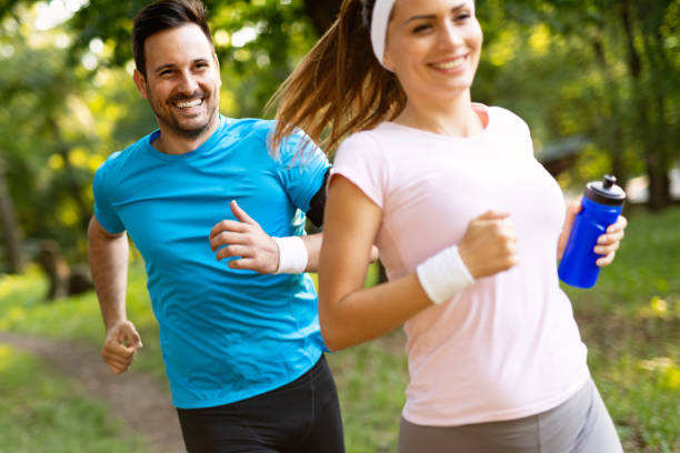 istock Happy couple jogging and running outdoors in nature 1171725302