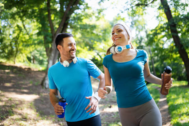 istock Happy couple jogging and running outdoors in nature 1171725614