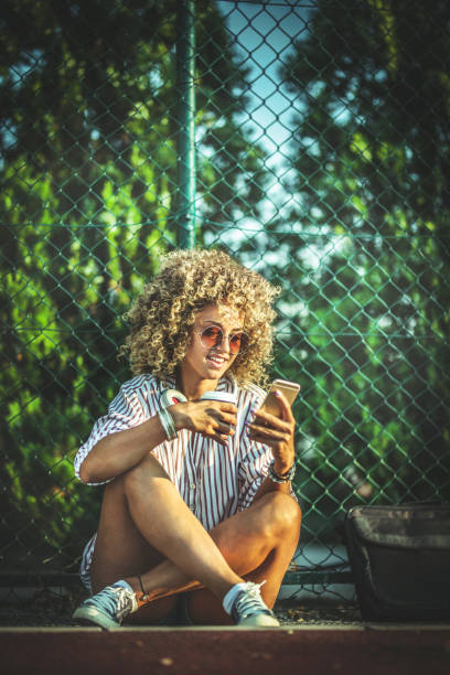 istock Beautiful woman using cellphone outdoors 1171730070
