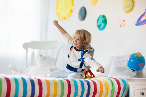istock Kids play astronaut. Space and planet child game. 1171730484