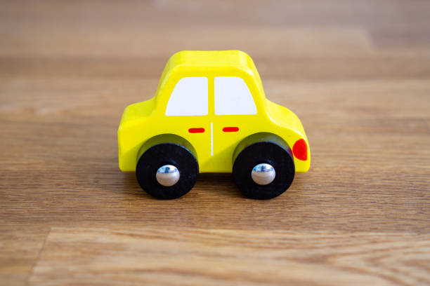 istock Yellow car on wooden table 1171730530