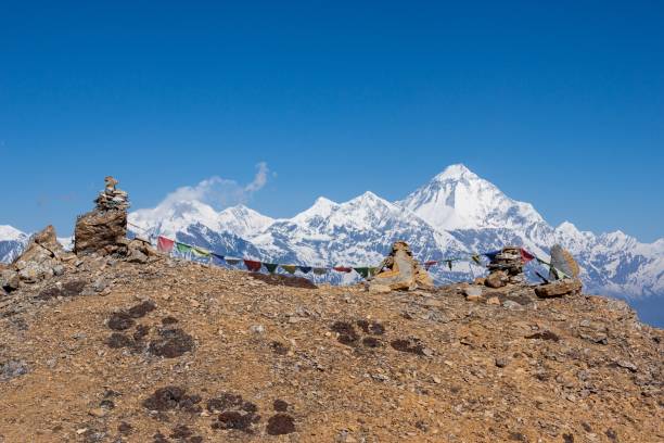 istock Buddhist prayer flags on cairns in Himalayas with mt. Dhaulagiri in background. 1171732183