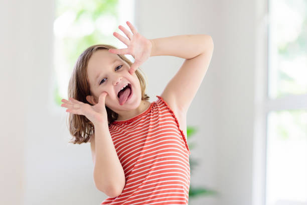 Child funny face. Kid teasing. Girl laughing. Child making funny face. Kid teasing and laughing. Silly little girl playing and smiling. teasing photos stock pictures, royalty-free photos & images