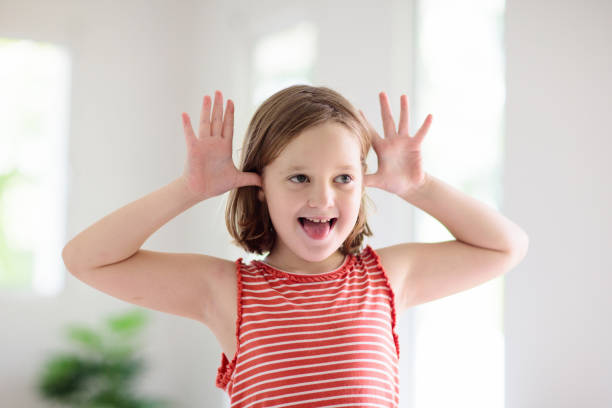 istock Child funny face. Kid teasing. Girl laughing. 1171732911