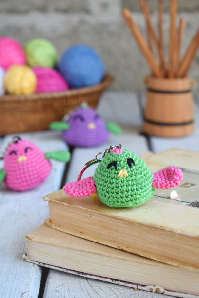 istock Colored crochet bird. Toy for babies or trinket.  Handmade gift. DIY crafts concept. 1171733105