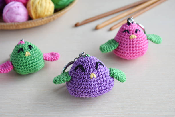 istock Making colored crochet bird. Toy for babies or trinket.  On the table threads, needles, hook, cotton yarn. Handmade gift. DIY crafts concept. 1171733107