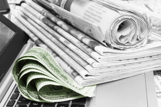 istock Stack of Newspapers, Money and Laptop 1171735097