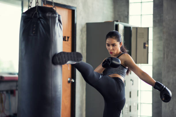 istock Woman practice Thai kick boxing in gym 1171735118