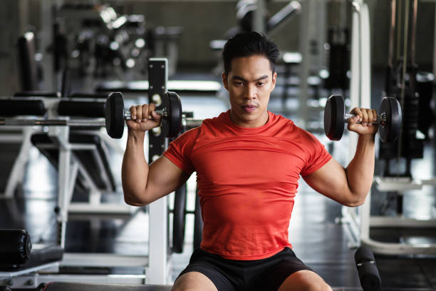 istock Muscular man exercise dumbbell in gym 1171735133