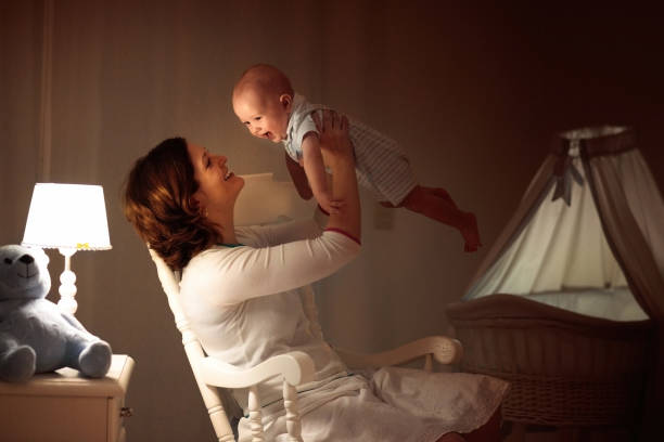 istock Mother and baby in dark bedroom 1171736695