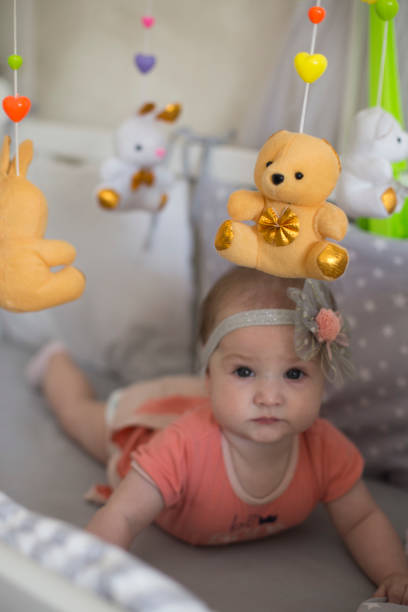 istock Beautiful baby girl playing on bed 1171736802