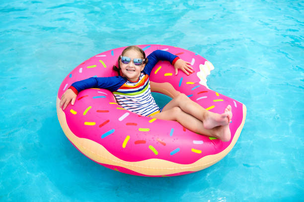 istock Child in swimming pool on donut float 1171737007