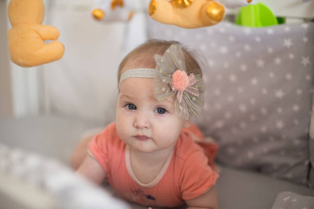 istock Beautiful baby girl playing on bed 1171737533