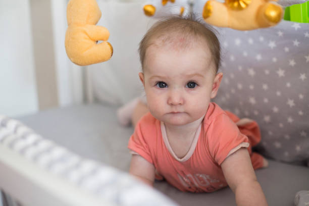 istock Beautiful baby girl playing on bed 1171737652