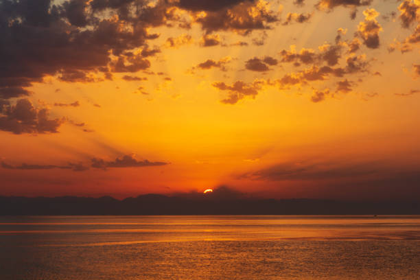 istock Sea landscape with sunrise, mountains and cloudy sky 1171738361