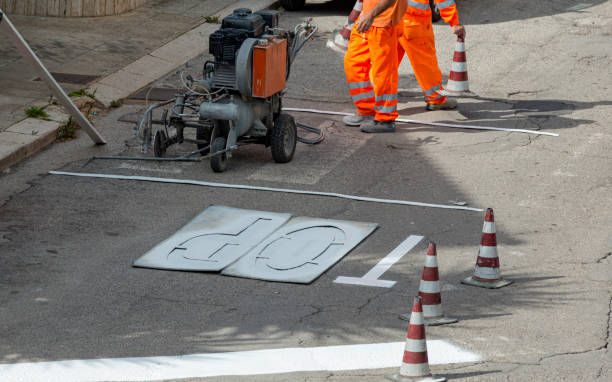 istock machine and workers at road construction use for road and traffic sign painting 1171739596