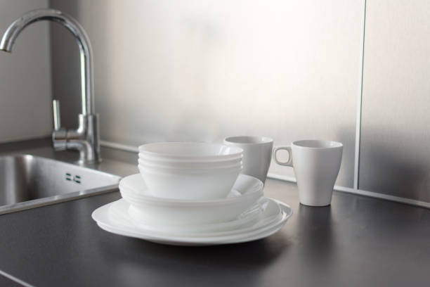 istock Set of fresh washed plates and cutlery on the kitchen table. 1171740242
