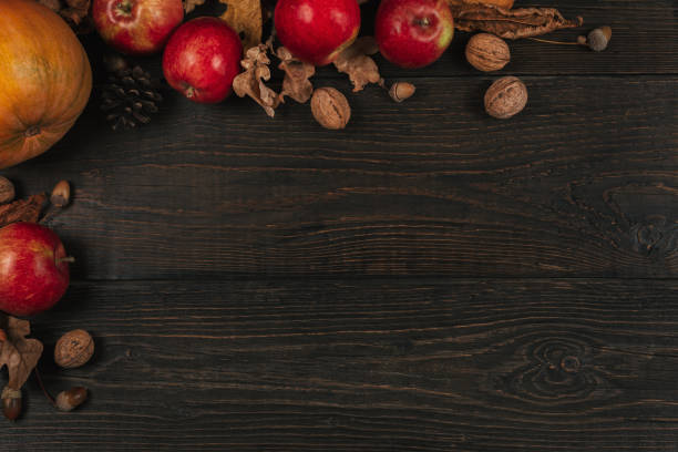 istock Autumn background with pumpkin, apples and nuts. Dark rustic wooden background. 1171741833