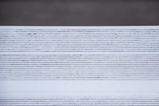 View of texture of metal bench in bleachers of football, baseball or soccer stadium