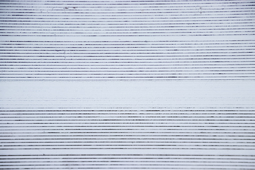 View directly overhead of pattern on metal bleachers in stadium of local high school for baseball, football or soccer sports game