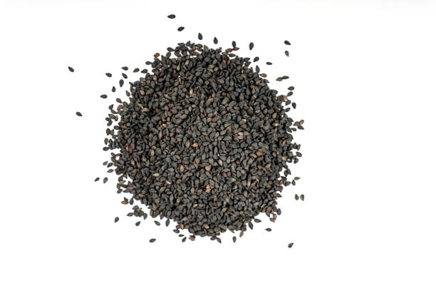 Black sesame seeds isolated on a white background.