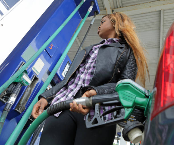 istock Young woman refuels her car 1171746390