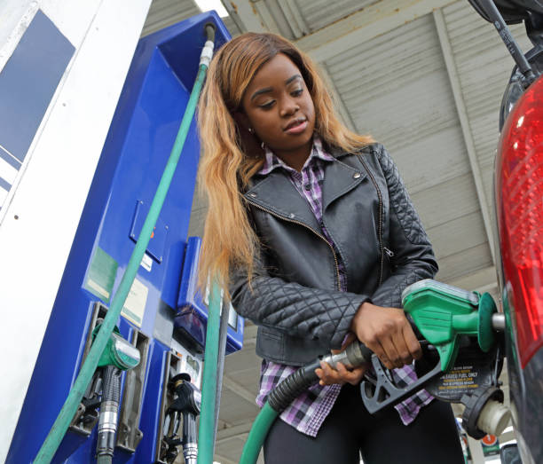 istock Young woman refuels her car 1171746414
