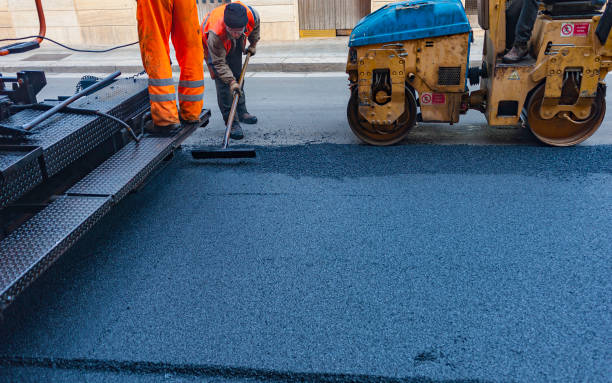 istock Worker regulate tracked paver laying asphalt heated to temperatures above 160 ° pavement on a runway 1171747698