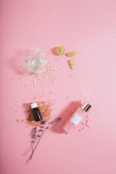 istock Creative flat lay top view bottles mock up and vase on pastel millennial pink paper background copy space. Template for text lettering blogging 1171747901
