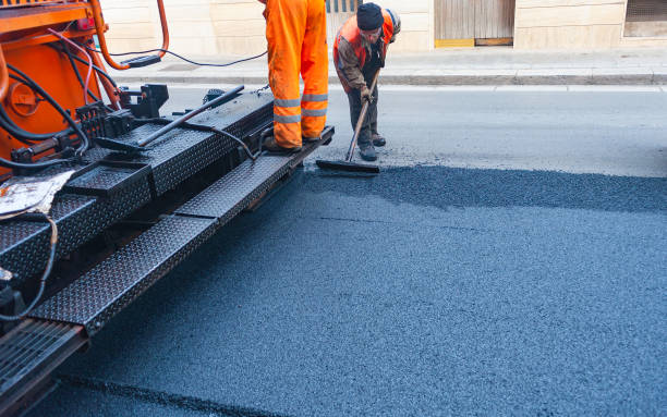 istock Worker regulate tracked paver laying asphalt heated to temperatures above 160 ° pavement on a runway 1171747919